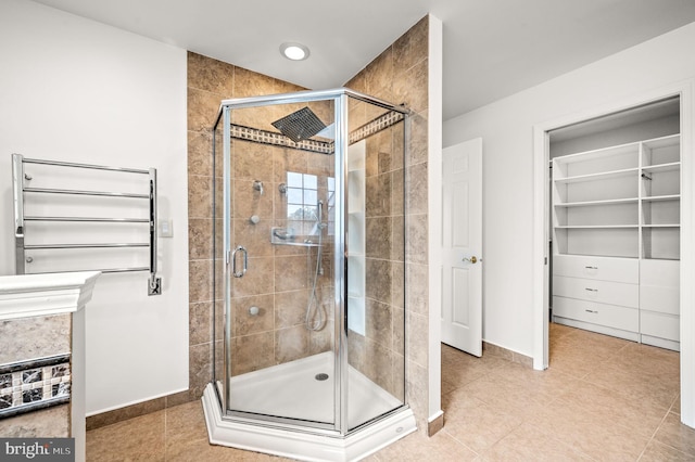 bathroom featuring walk in shower and tile patterned flooring