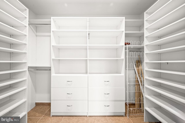 walk in closet featuring light tile patterned flooring