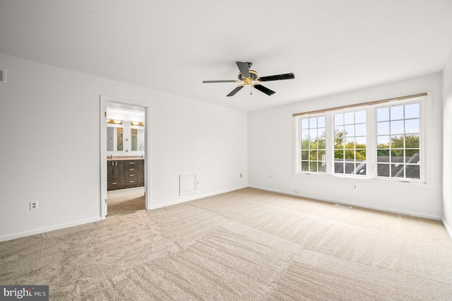 empty room with light carpet and ceiling fan