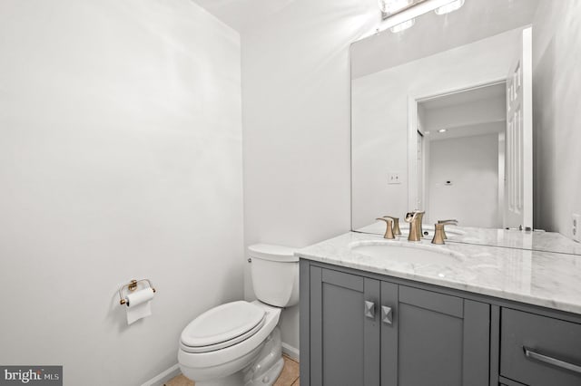 bathroom with tile patterned flooring, vanity, and toilet