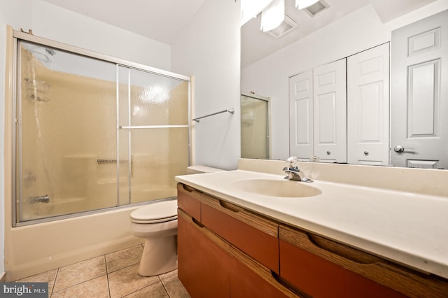 full bathroom with vanity, tile patterned flooring, toilet, and combined bath / shower with glass door