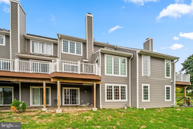 rear view of property with a yard