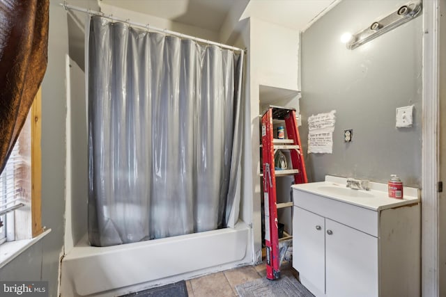 bathroom featuring shower / bath combo with shower curtain, tile patterned floors, and vanity