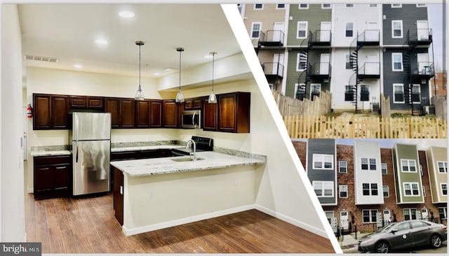 kitchen with appliances with stainless steel finishes, dark wood-type flooring, kitchen peninsula, light stone countertops, and pendant lighting