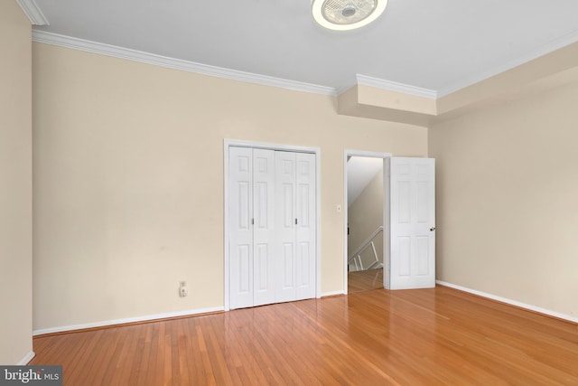 unfurnished bedroom featuring hardwood / wood-style floors and ornamental molding