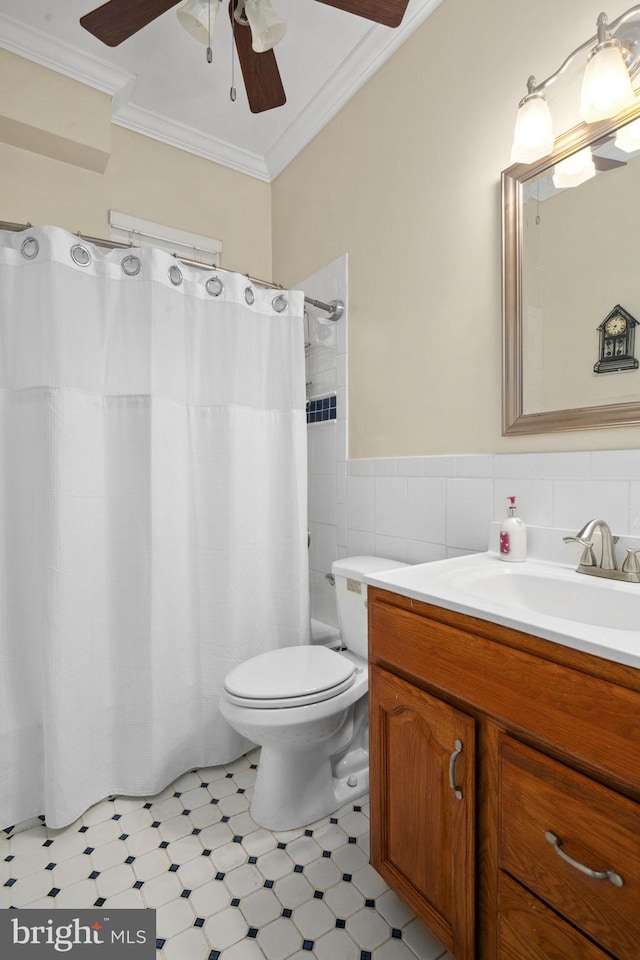 full bathroom with ornamental molding, vanity, shower / tub combo with curtain, tile walls, and toilet