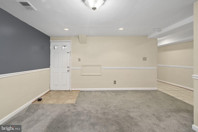 unfurnished room featuring light carpet