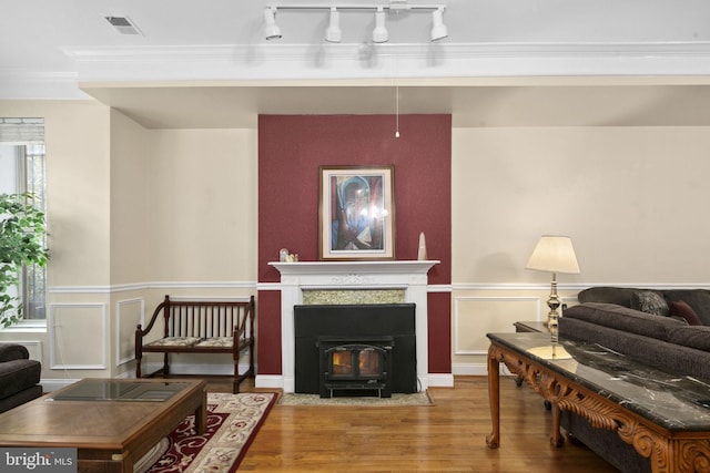 living room with wood-type flooring and crown molding