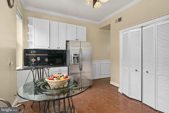 kitchen featuring decorative backsplash, white cabinetry, stainless steel fridge with ice dispenser, and ornamental molding