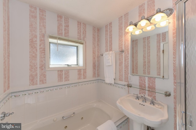 bathroom featuring a washtub and sink