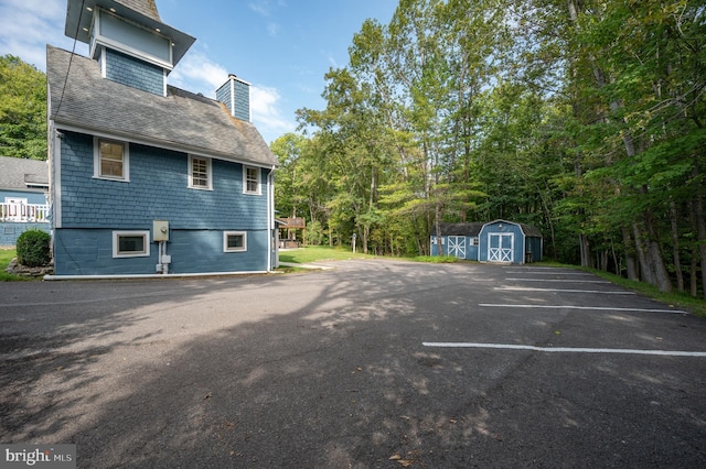 view of side of property with a storage shed