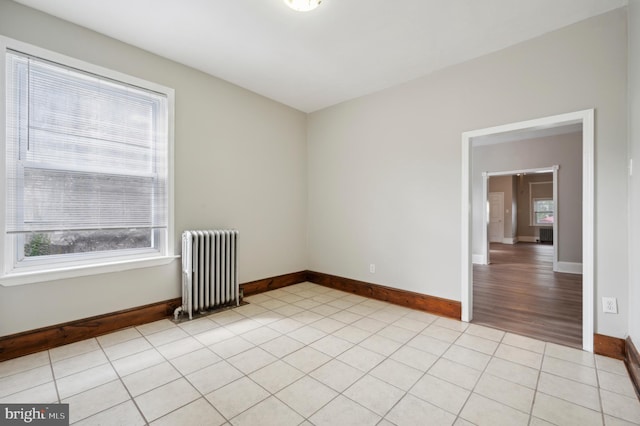 empty room featuring radiator and light wood-type flooring