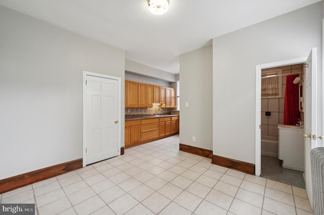 kitchen featuring decorative backsplash and light tile patterned floors