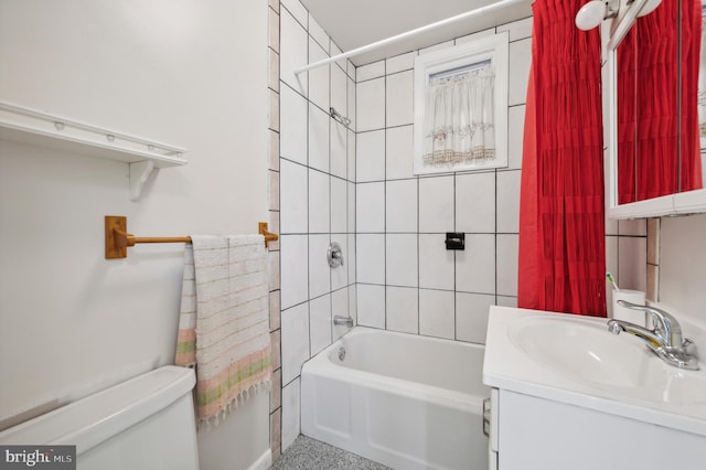 full bathroom featuring vanity, toilet, and tiled shower / bath