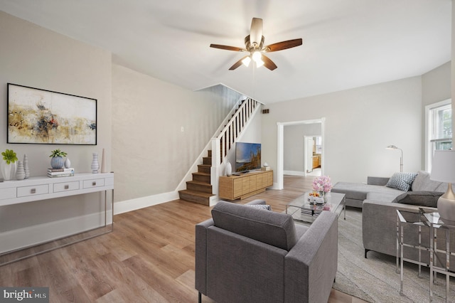 living room with ceiling fan and light hardwood / wood-style floors