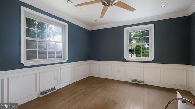 unfurnished room with ceiling fan, light hardwood / wood-style floors, and ornamental molding