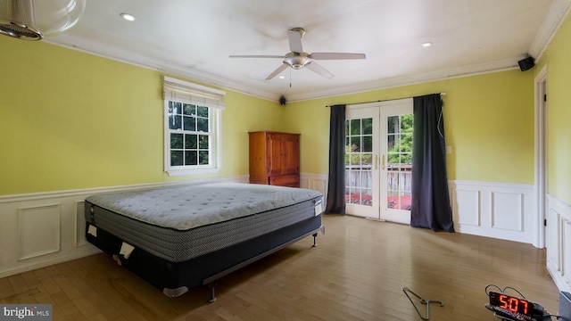 bedroom with access to exterior, crown molding, ceiling fan, french doors, and hardwood / wood-style flooring