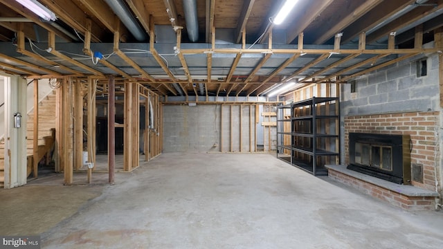 basement featuring a brick fireplace