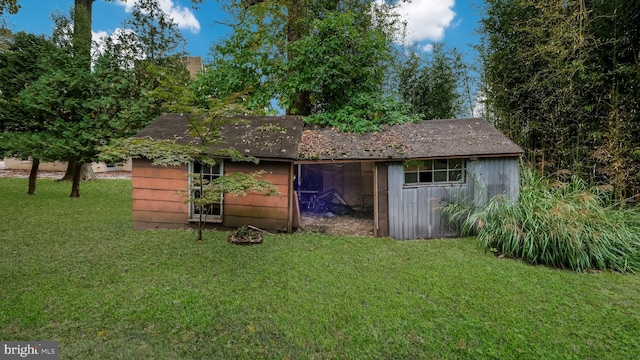 view of outdoor structure featuring a lawn