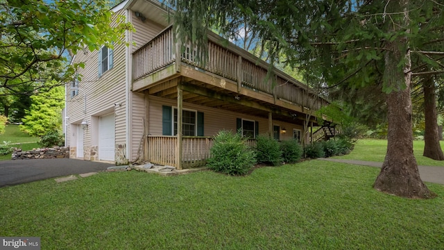 view of property exterior featuring a lawn and a garage