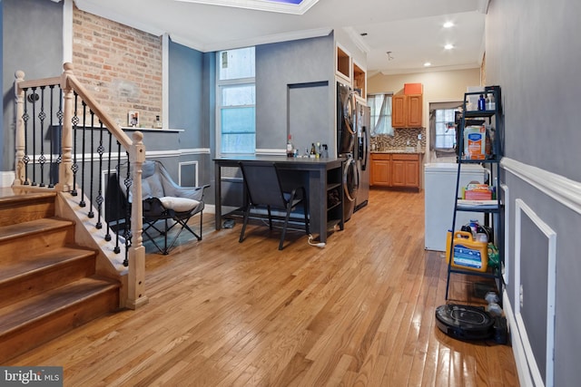 kitchen featuring stainless steel refrigerator, backsplash, crown molding, and light wood-type flooring