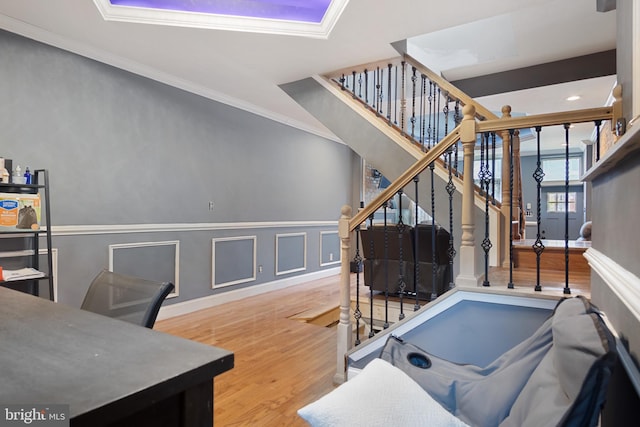 interior space featuring wood-type flooring and crown molding