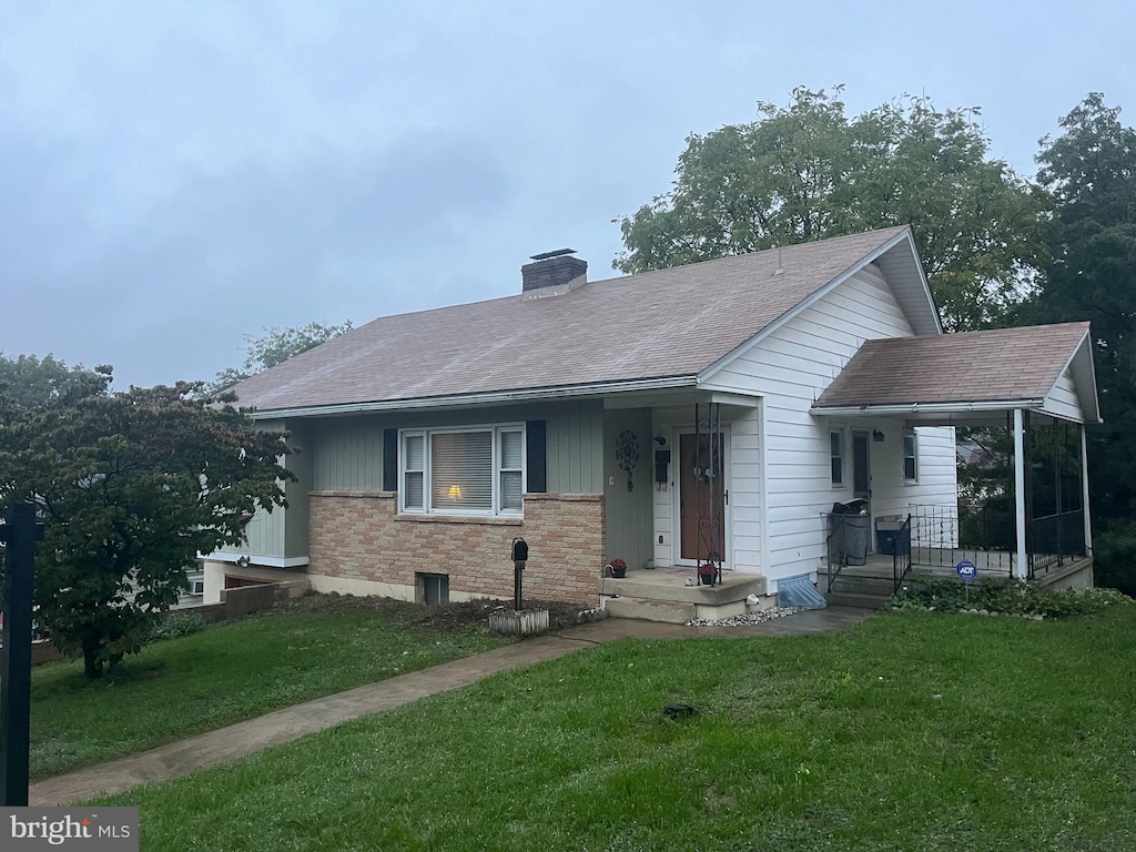 bungalow-style house featuring a front lawn