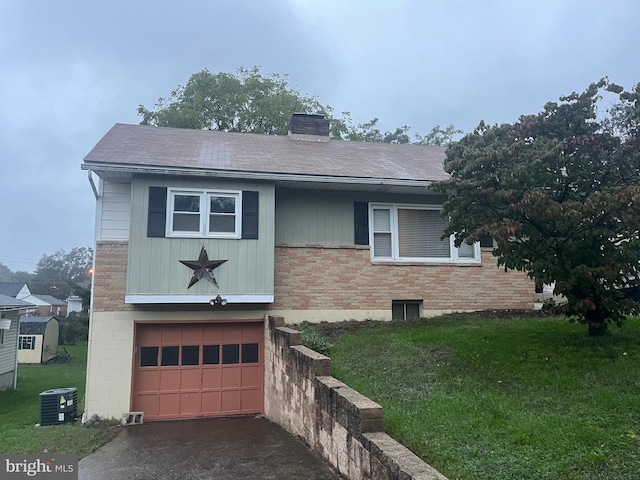 view of front of house featuring a front yard, a garage, and central air condition unit