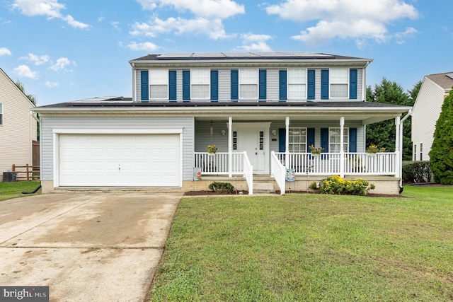 view of front of property featuring covered porch, a front yard, and a garage