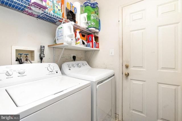 clothes washing area with washing machine and clothes dryer