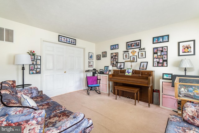 living room with light carpet and a textured ceiling