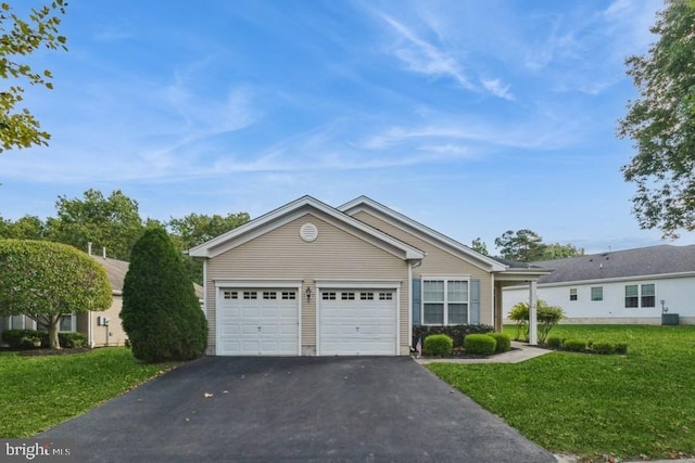 view of front of house featuring a garage and a front lawn