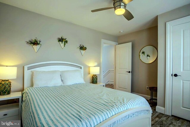 bedroom with ceiling fan and dark hardwood / wood-style flooring