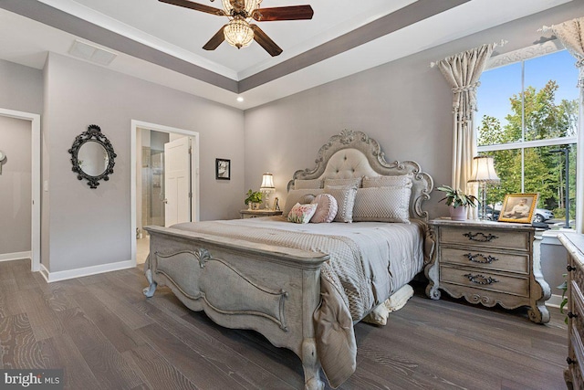 bedroom with connected bathroom, dark hardwood / wood-style flooring, and ceiling fan