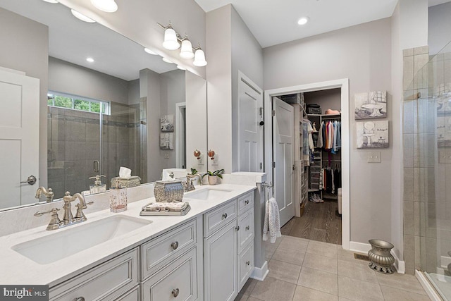 bathroom with vanity, an enclosed shower, and tile patterned floors