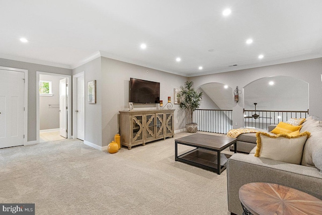 living room with ornamental molding and light carpet