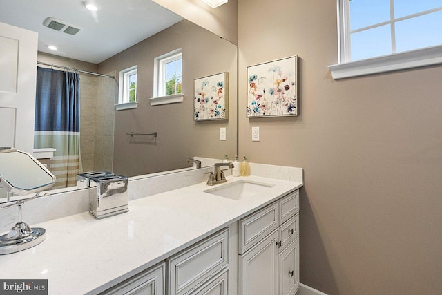 bathroom with vanity and curtained shower