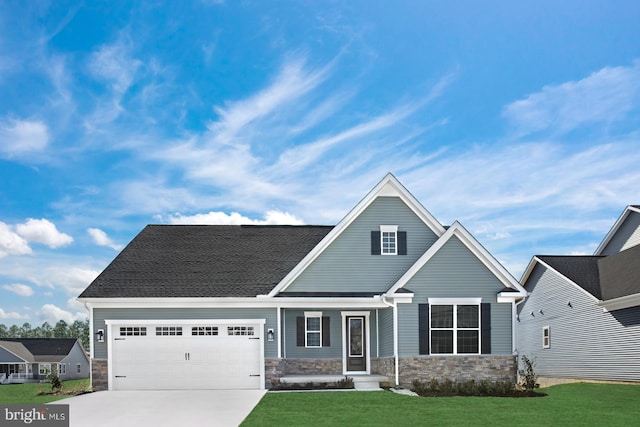 craftsman-style home featuring a garage and a front yard