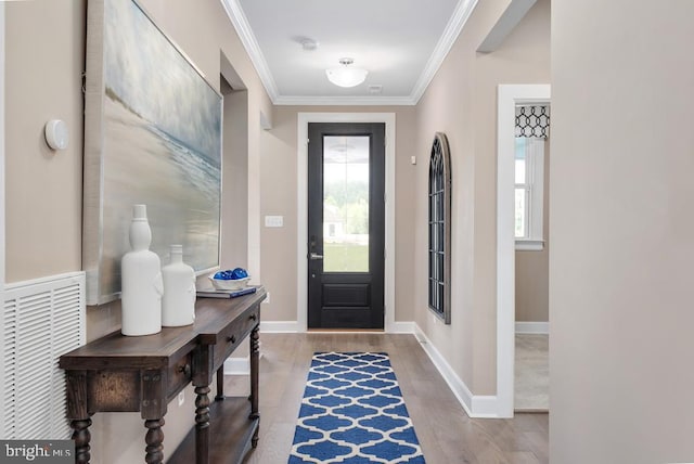 entryway featuring light hardwood / wood-style flooring and crown molding