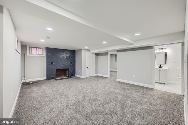 interior space featuring carpet flooring, sink, and a brick fireplace