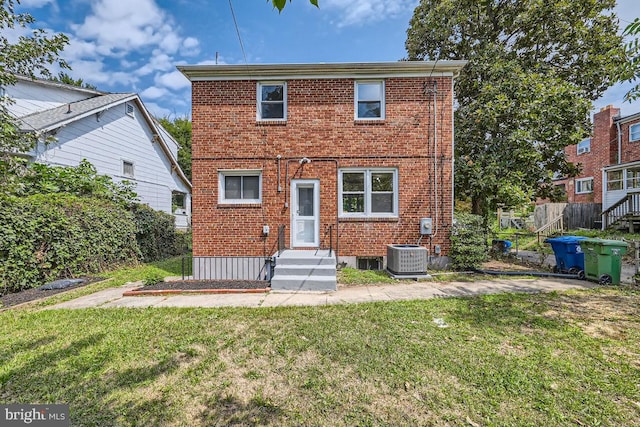 view of front facade with central AC unit and a front yard