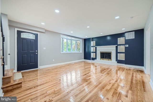 unfurnished living room with light wood-type flooring