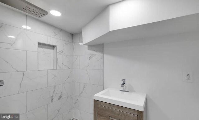 bathroom featuring vanity and a tile shower