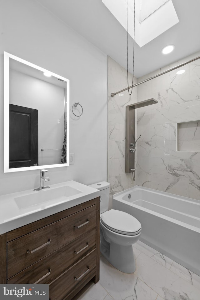 full bathroom with tiled shower / bath combo, toilet, vanity, and a skylight