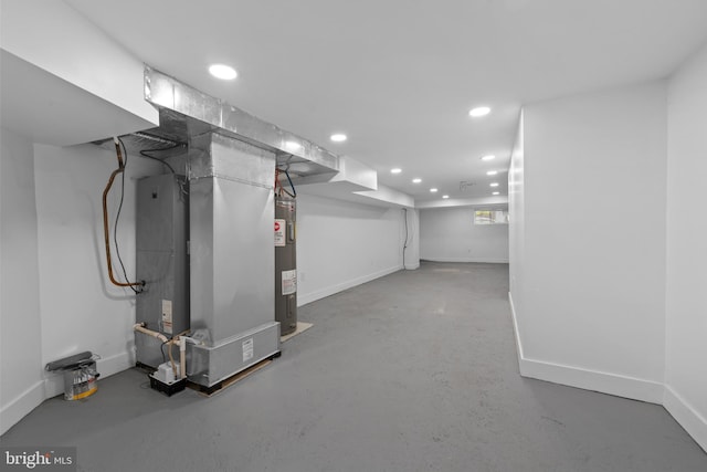 basement with electric water heater and heating unit