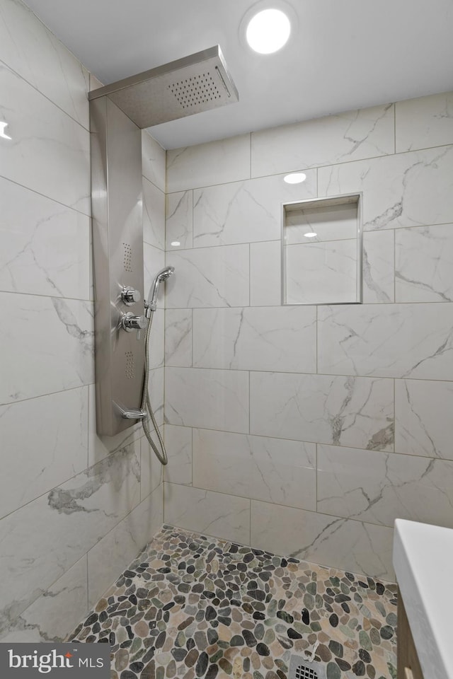 bathroom with tiled shower