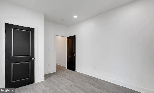 empty room with light hardwood / wood-style floors