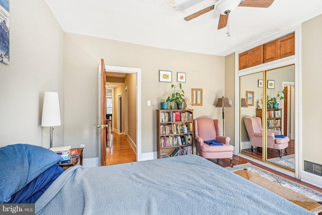 bedroom featuring a closet, hardwood / wood-style flooring, and ceiling fan