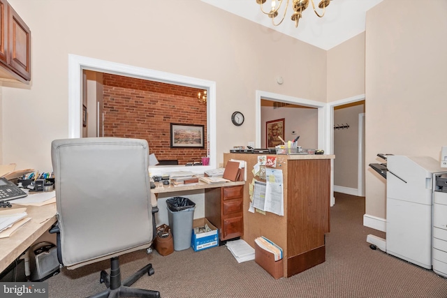 carpeted home office with an inviting chandelier