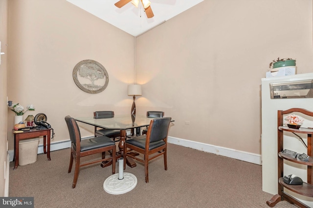 carpeted dining area featuring ceiling fan, baseboard heating, and vaulted ceiling